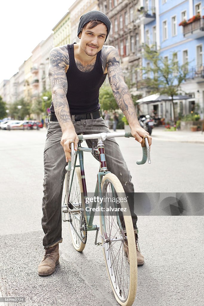 Young cyclist with tattoos in Berlin