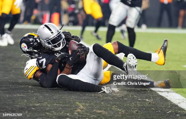 Davante Adams of the Las Vegas Raiders scores a touchdown while defended by Levi Wallace of the Pittsburgh Steelers during the fourth quarter at...