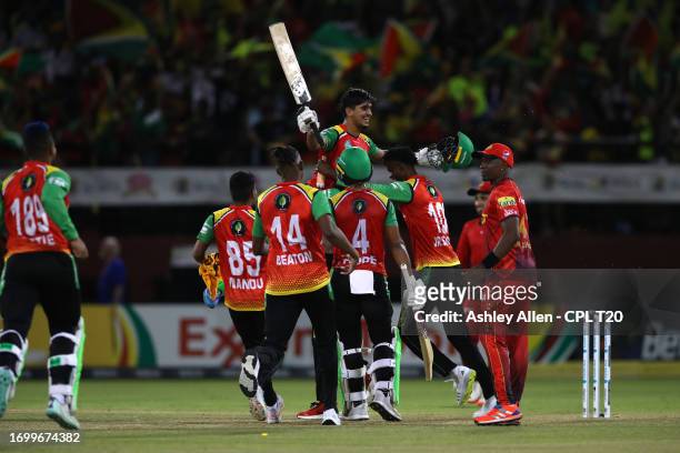 Siam Ayub of Guyana Amazon Warriors is lifted up by his teammates after he hits the winning runs during the Republic Bank Caribbean Premier League...