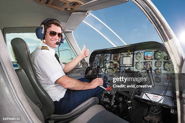 young pilot in aircraft cockpit giving thumbs up - cockpit 個照片及圖片檔