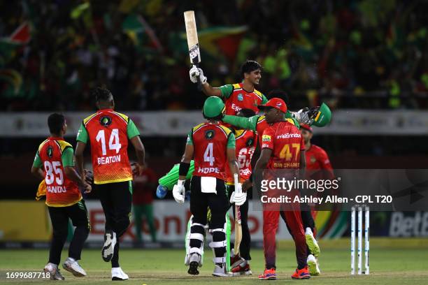 Siam Ayub of Guyana Amazon Warriors is lifted up by his teammates after he hits the winning runs during the Republic Bank Caribbean Premier League...