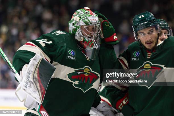 Minnesota Wild goaltender Filip Gustavsson celebrates a win with defenseman Ryan O'Rourke after the NHL Preseason game between the Chicago Blackhawks...