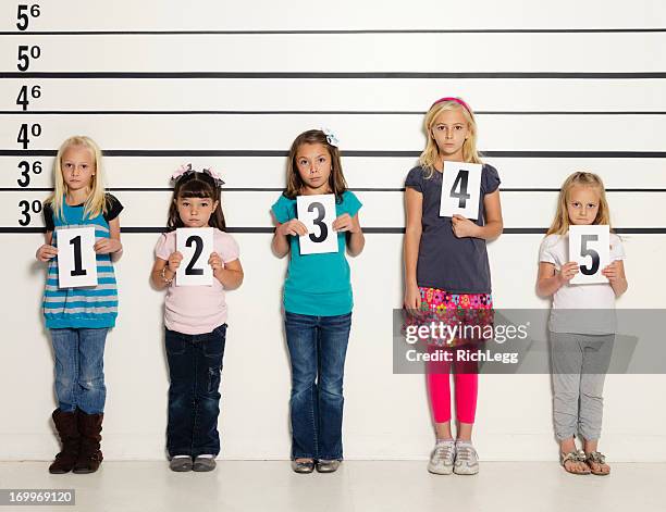 police line-up of five little girls - police line up stock pictures, royalty-free photos & images