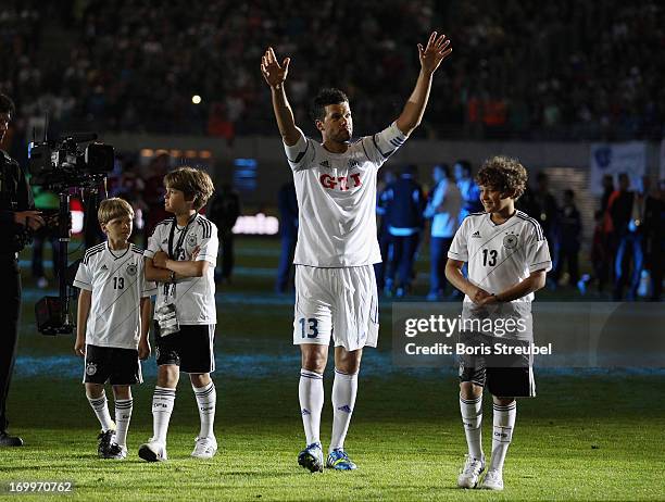 Michael Ballack and his three sons Jordi, Emilio and Louis wave to the fans after the Michael Ballack farewell match at Red Bull Arena on June 5,...