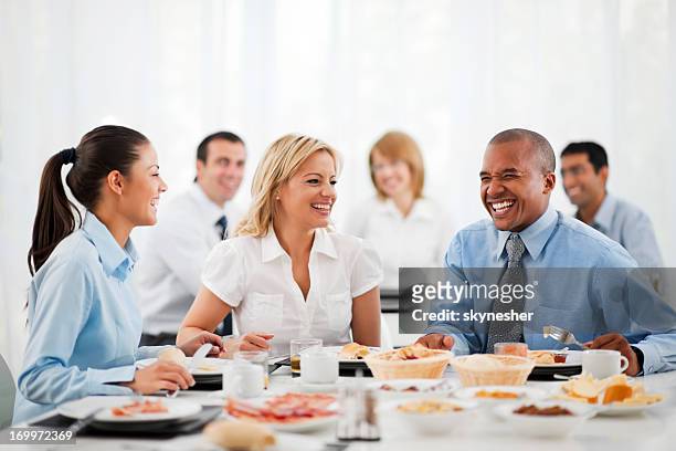 business people standing around table at lunch - corporate lunch stock pictures, royalty-free photos & images