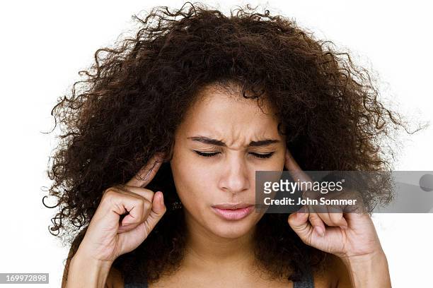 woman with fingers in ears - woman fingers in ears stock pictures, royalty-free photos & images