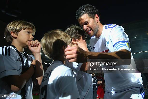 Michael Ballack reacts with his sons after the Michael Ballack farewell match at Red Bull Arena on June 5, 2013 in Leipzig, Germany.