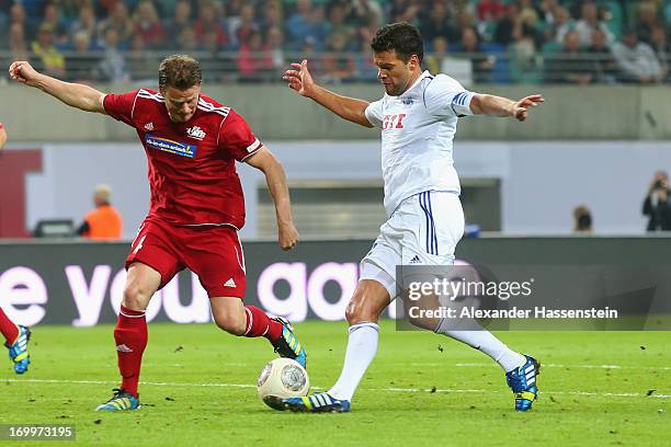 Christian Woerns of team Michael Ballack battles for the ball with Michael Ballack during the Michael Ballack farewell match at Red Bull Arena on...