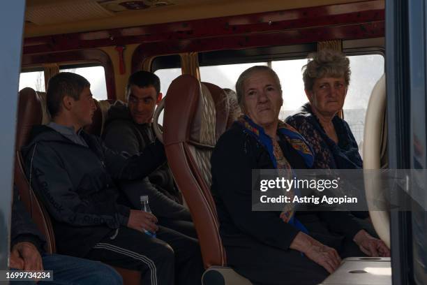 Armenians from Nagorno-Karabakh who fled their homes are put on a bus to evacuate to Goris at a humanitarian hub on September 24, 2023 in Kornidzor,...