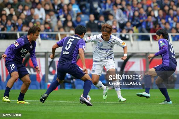 Takashi Usami of Gamba Osaka controls the ball against Sanfrecce Hiroshima defense during the J.League Yamazaki Nabisco Cup final match between...