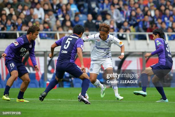 Takashi Usami of Gamba Osaka controls the ball against Sanfrecce Hiroshima defense during the J.League Yamazaki Nabisco Cup final match between...