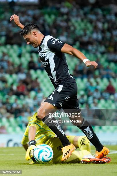 Gibran Lajud goalkeeper of Santos fights for the ball with Ricardo Monreal of Necaxa during the 9th round match between Santos Laguna and Necaxa as...