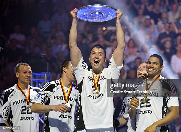 Momir Ilic holds the Bundesliga trophy as the players of THW Kiel present the Bundesliga trophy to the fans at the Sparkasse Arena on June 5, 2013 in...