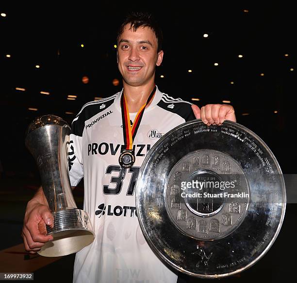 Momir Ilic holds the Cup and the Bundesliga trophy as the players of THW Kiel present the Bundesliga trophy to the fans at the Sparkasse Arena on...