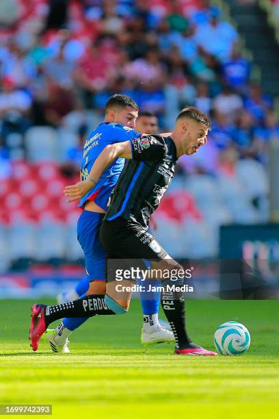 Erik Lira of Cruz Azul fights for the ball with Federico Lertora of Queretaro during the 9th round match between Cruz Azul and Queretaro as part of...