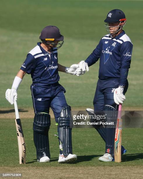 Marcus Harris of Victoria and Thomas Rogers of Victoria bump gloves during the Marsh One Day Cup match between Victoria and Tasmania at CitiPower...