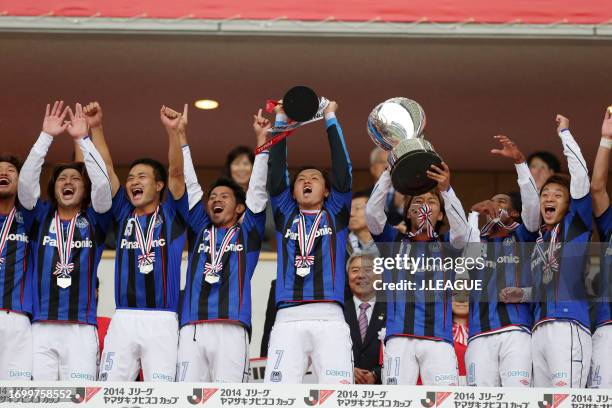 Captain Yasuhito Endo of Gamba Osaka lifts the trophy at the award ceremony following the J.League Yamazaki Nabisco Cup final match between Sanfrecce...