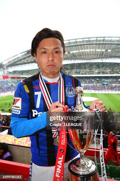 Captain Yasuhito Endo of Gamba Osaka poses with the trophy at the award ceremony following the J.League Yamazaki Nabisco Cup final match between...
