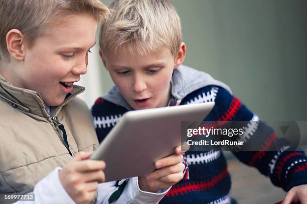 boys with a tablet computer - educational game stock pictures, royalty-free photos & images