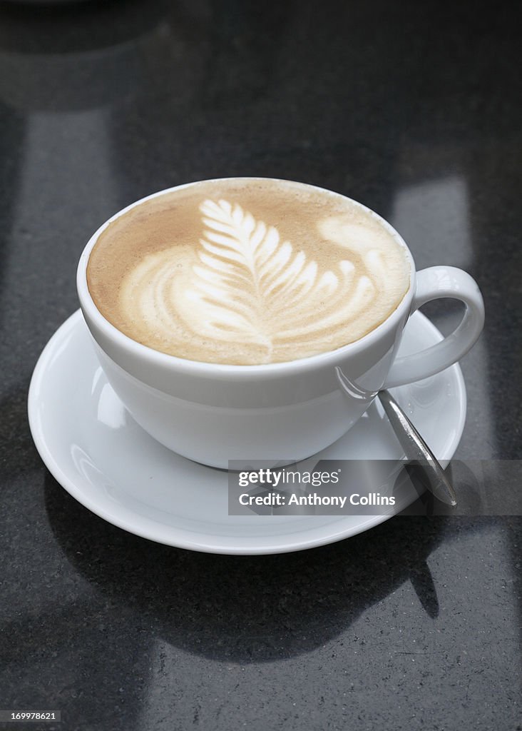 Cafe latte or flat white coffee on a granite table