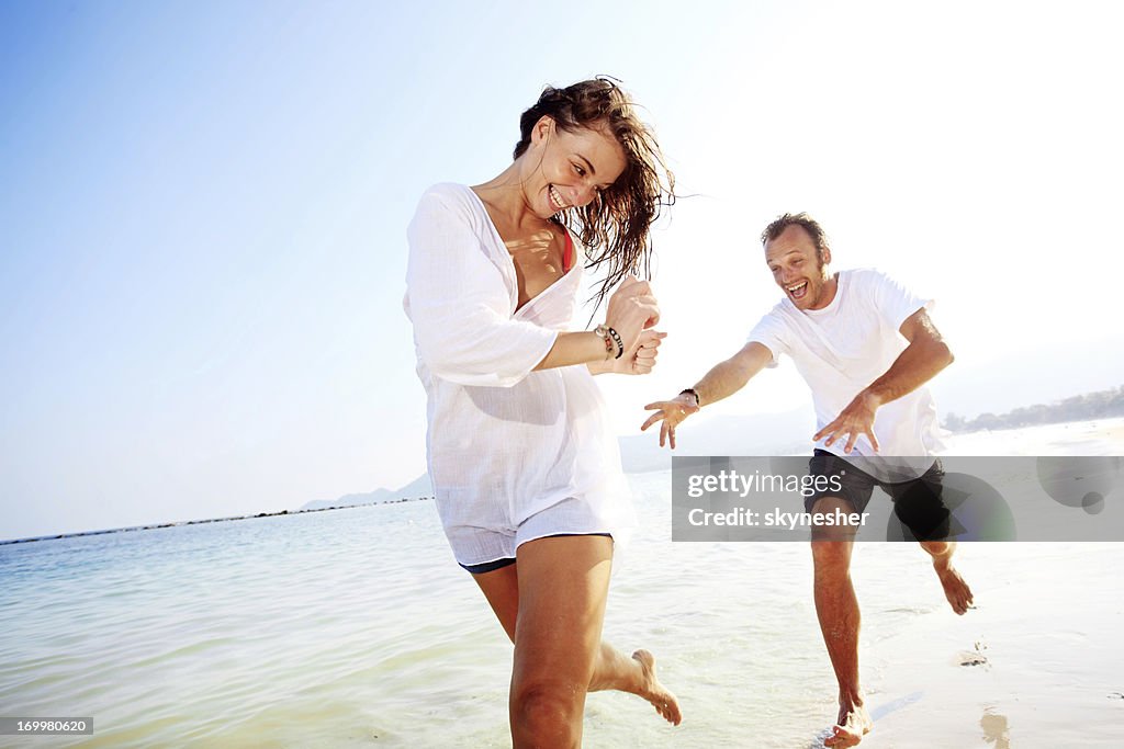 Cheerful couple having fun on the beach.