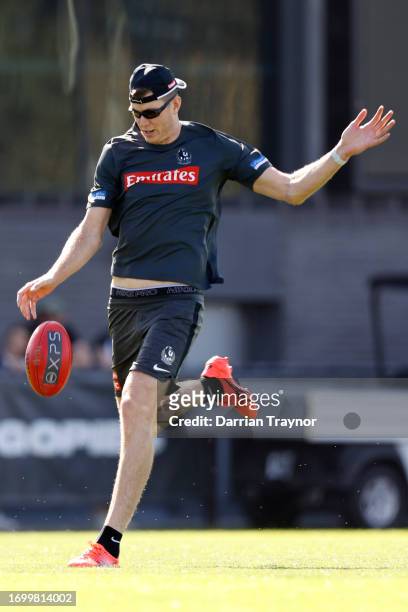 Mason Cox of the Magpies kicks the ball during a Collingwood Magpies AFL training session at AIA Centre on September 25, 2023 in Melbourne, Australia.