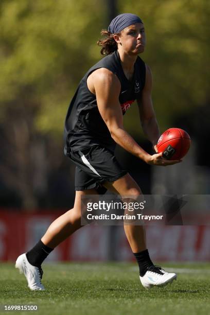 Jack Ginnivan of the Magpies handballs during a Collingwood Magpies AFL training session at AIA Centre on September 25, 2023 in Melbourne, Australia.