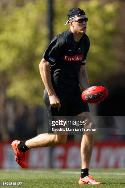 Mason Cox of the Magpies handballs during a Collingwood Magpies AFL training session at AIA Centre on September 25, 2023 in Melbourne, Australia.