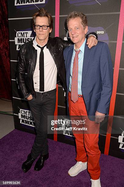 Kevin Bacon and Michael Bacon of the band The Bacon Brothers arrive at the 2013 CMT Music Awards at the Bridgestone Arena on June 5, 2013 in...