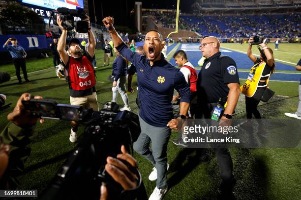 Head coach Marcus Freeman of the Notre Dame Fighting Irish celebrates following their game against the Duke Blue Devils at Wallace Wade Stadium on...
