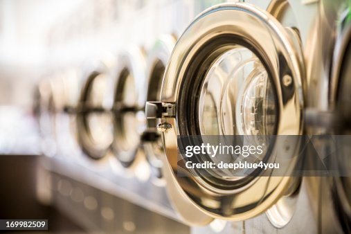 Washing machines - clothes washer’s door in a public launderette Washing machines - clothes washer’s door in a public launderette