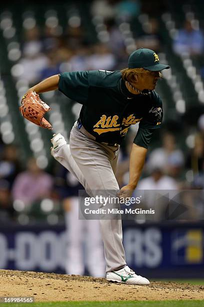 Hideki Okajima of the Oakland Athletics pitches in the bottom of the eighth inning against the Milwaukee Brewers during the interleague game at...