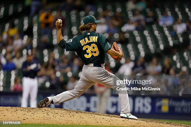 Hideki Okajima of the Oakland Athletics pitches in the bottom of the eighth inning against the Milwaukee Brewers during the interleague game at...