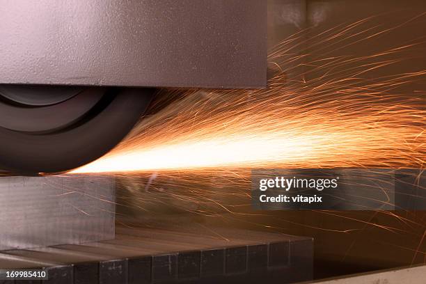 sliding grinder with sparks - slijptol stockfoto's en -beelden