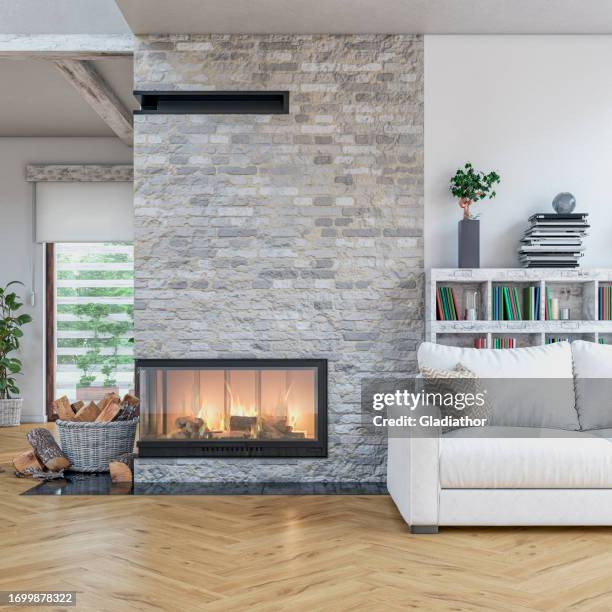 cozy, luxurious, and modern  living room with white sofa, lit fireplace, windows, with decoration - fireplace stock pictures, royalty-free photos & images