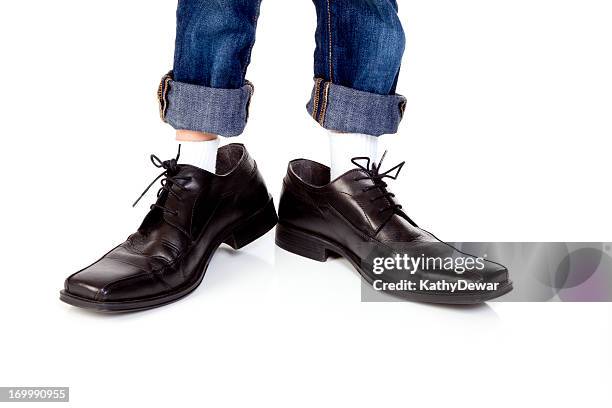 young boy wearing dads shoes - kid in big shoes stock pictures, royalty-free photos & images