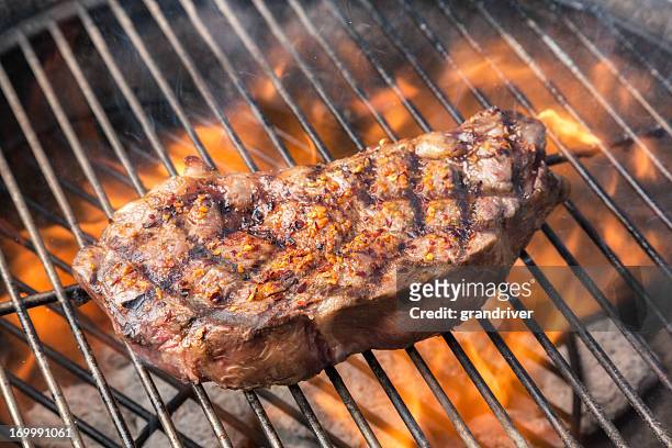 kobe new york steak on grill with fire - grilled steak stock pictures, royalty-free photos & images