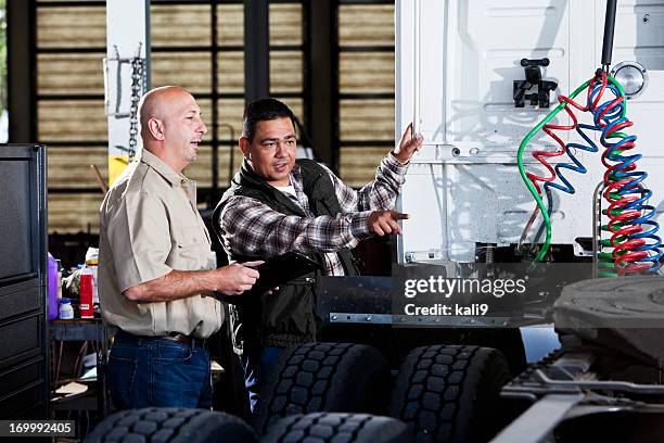 men in garage with semi-truck - truck repair stock pictures, royalty-free photos & images