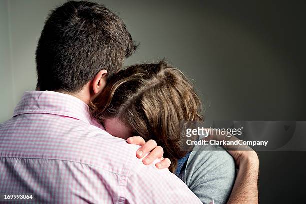 shoulder to cry on - mourning stock pictures, royalty-free photos & images