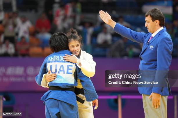 Diyora Keldiyorova of Team Uzbekistan hugs Khorloodoi Bishrelt of Team United Arab Emirates after the Judo Women's -52 kg Final on day one of the...