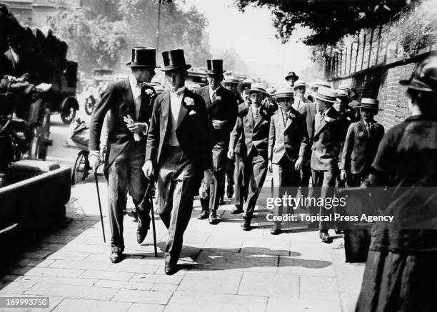 Eton schoolboys arriving at Lord's Cricket Ground, London, for the Eton versus Harrow cricket match, 13th July 1928.