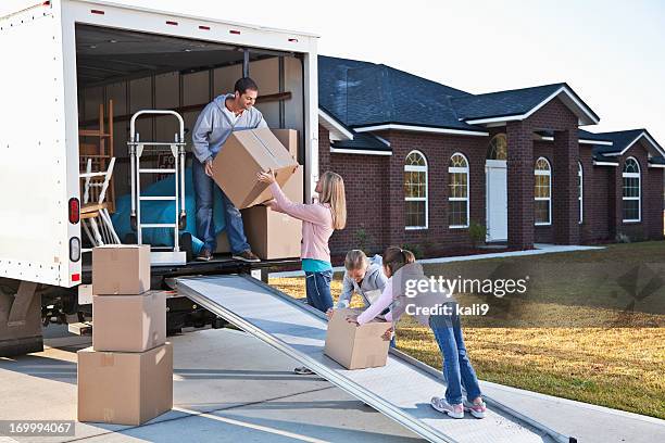 family moving house, unloading truck - moving van stock pictures, royalty-free photos & images