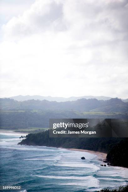 portrait view of sea with green mountianous coast - sumba stock pictures, royalty-free photos & images