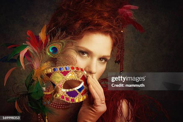 woman peeking out from behind a mask - fiesta posterior stock pictures, royalty-free photos & images