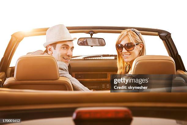 retro couple driving in old timer car. - convertible isolated stock pictures, royalty-free photos & images