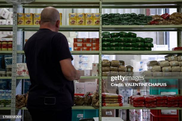 Didier Le Goff, supply manager and Terre-Rouge mutual aid and relations network association employee, consults stocks in the warehouse of RERTer, in...