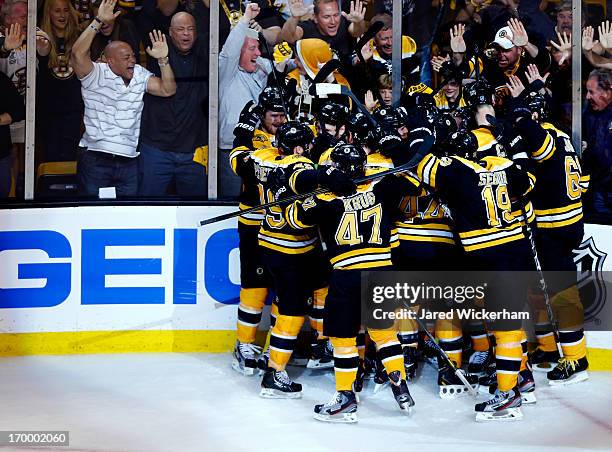 The Boston Bruins celebrate a double overtime victory, 2-1, over the Pittsburgh Penguins on a goal scored by Patrice Bergeron in Game Three of the...