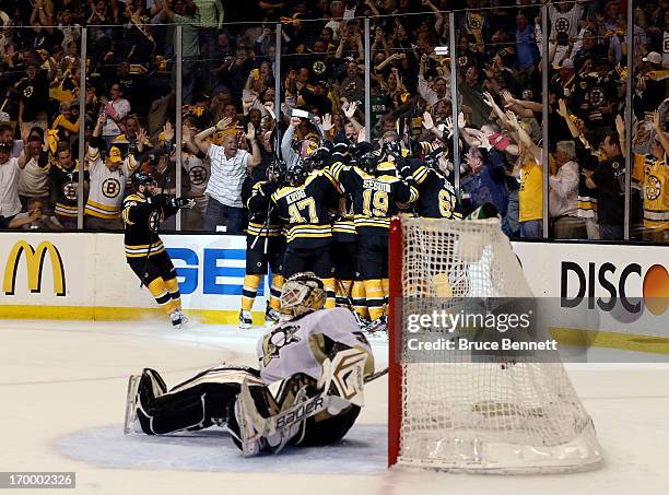 The Boston Bruins celebrate a double overtime victory, 2-1, over the Pittsburgh Penguins on a goal scored by Patrice Bergeron in Game Three of the...