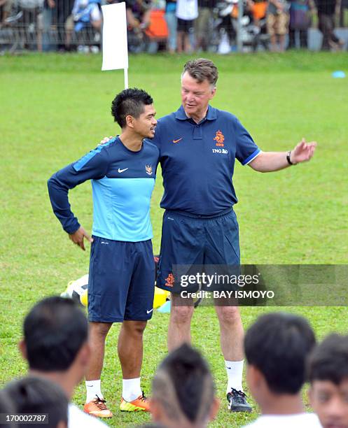 Dutch national football team coach Louis Van Gaal talks to Indonesia national football team captain Bambang Pamungkas during a coaching clinic for...