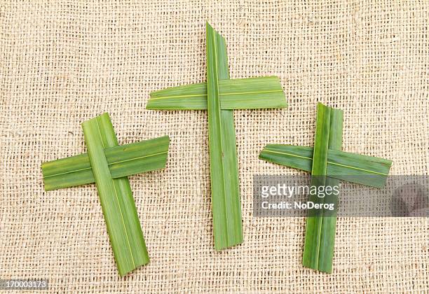 three palm crosses on a burlap background - palm sunday stock pictures, royalty-free photos & images